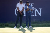 United States' Collin Morikawa, right, holds the claret jug trophy with the leading amateur Germany's Matthias Schmid on 18th green after winning the British Open Golf Championship at Royal St George's golf course Sandwich, England, Sunday, July 18, 2021. (AP Photo/Peter Morrison)