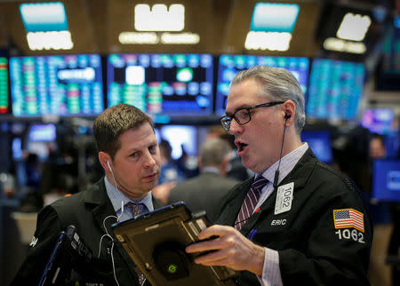 Traders work on the floor of the New York Stock Exchange (NYSE) in New York, U.S., April 18, 2018. REUTERS/Brendan McDermid