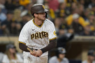 San Diego Padres' Wil Myers holds the end of his broken bat as he watches his RBI single during the eighth inning of the team's baseball game against the Pittsburgh Pirates, Friday, May 27, 2022, in San Diego. (AP Photo/Gregory Bull)