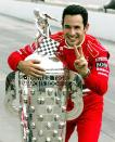 FILE PHOTO: Helio Castroneves holds the Borg Warner Trophy at the Indianapolis Motor Speedway a day after he became the first driver in 31 years to defend his crown, scoring a controversial victory over Canada's Paul Tracy