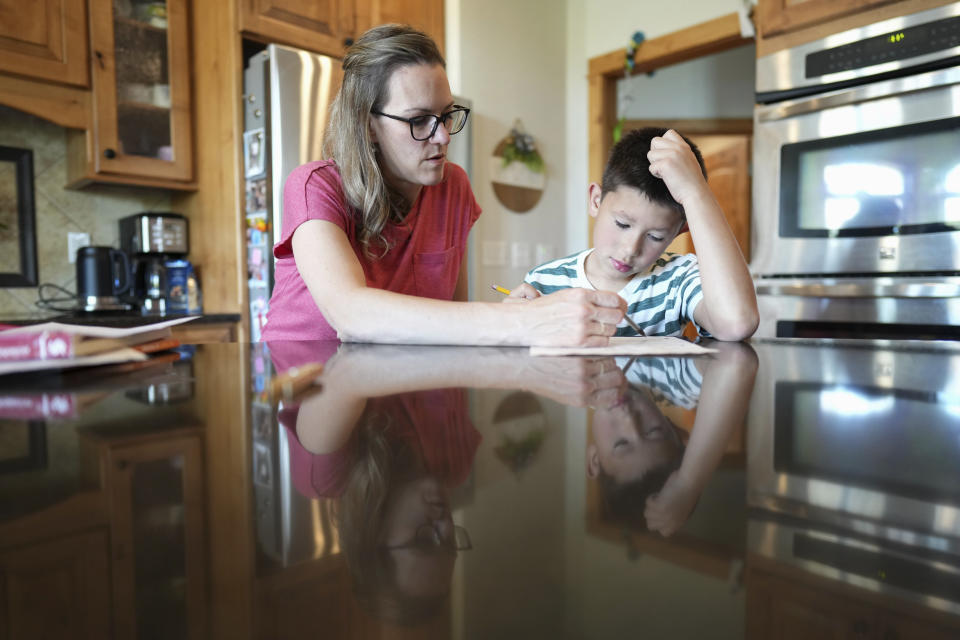 Amanda Visser homeschools her adopted eight-year-old son Elliott in their home, Monday, May 13, 2024, in Sterling, Colorado. (AP Photo/Jack Dempsey)