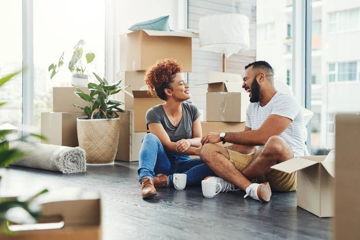 A couple with moving boxes around them