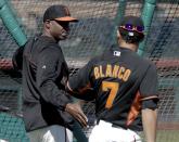 San Francisco Giants former player Barry Bonds, left, greets center fielder Gregor Blanco during batting practice before a spring training baseball game between the Giants and the Chicago Cubs in Scottsdale, Ariz., Monday, March 10, 2014. Bonds starts a seven day coaching stint today. (AP Photo/Chris Carlson)