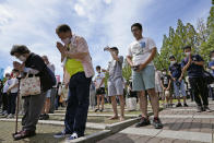 People offer silent prayers during a ceremony to mark the 77th anniversary of the U.S. atomic bombing in Nagasaki, southern Japan, Tuesday, Aug. 9, 2022. (Kyodo News via AP)