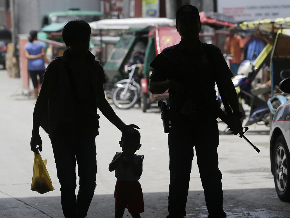 <p>A policeman stands at a checkpoint in Manila, Philippines, May 24, 2017 as the Philippine National Police is placed under full alert status following the declaration of martial law in Mindanao southern Philippines. Philippine President Rodrigo Duterte warned Wednesday that he’ll be harsh in enforcing martial law in his country’s south as he abruptly left Moscow to deal with a crisis at home sparked by a Muslim extremist siege on a city, where militants burned buildings overnight and are feared to have taken hostages. (Photo: Aaron Favila/AP) </p>