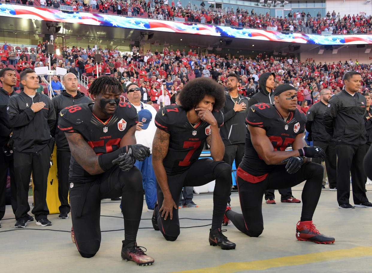 San Francisco 49ers outside linebacker Eli Harold (58), quarterback Colin Kaepernick (7) and free safety Eric Reid (35) kneel in protest during the national anthem before an NFL game at Levi's Stadium on Oct. 16, 2016. (Photo: Kirby Lee/USA Today Sports via Reuters)