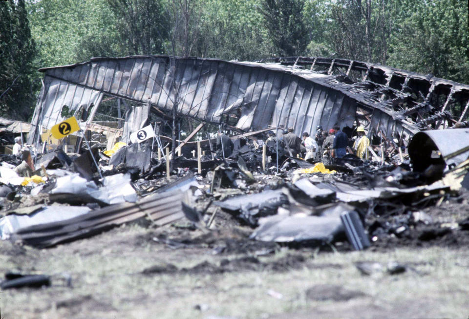 FILE - In this May 26, 1979 file photo, investigators view the wreckage of the ill-fated American Airlines Flight 191 to Los Angeles, which crashed on take off in Chicago. Decades later, the crash, moments after it took off from Chicago's O'Hare International Airport, remains the deadliest aviation accident in U.S. history. The DC-10 was destined for Los Angeles when it lost one of its engines May 25, 1979, killing what investigators later determined were 273 people _ all 271 people aboard the jetliner and two people on the ground. (AP Photo/Fred Jewell File)