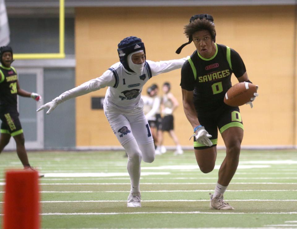 Jayden Stephens (0) runs for extra yards during a 7-on-7 football tournament Saturday at the UNI Dome in Cedar Falls.