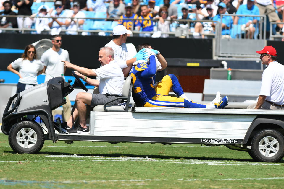 CHARLOTTE, NC - SEPTEMBER 08: Los Angeles Rams free safety Eric Weddle (32) gets carted off the field after getting injured on a tacle attempt on Carolina Panthers running back Christian McCaffrey (22) during the game between the Los Angeles Rams and the Carolina Panthers on September 08, 2019 at Bank of America Stadium in Charlotte,NC. (Photo by Dannie Walls/Icon Sportswire via Getty Images)