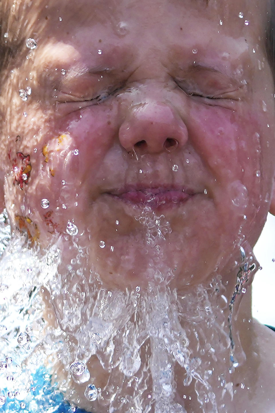 A boy cools off at a fountain outside Wrigley Field before a baseball game between the Chicago Cubs and St. Louis Cardinals as hot weather dominates the weather in Chicago, Sunday, June 16, 2024. (AP Photo/Nam Y. Huh)