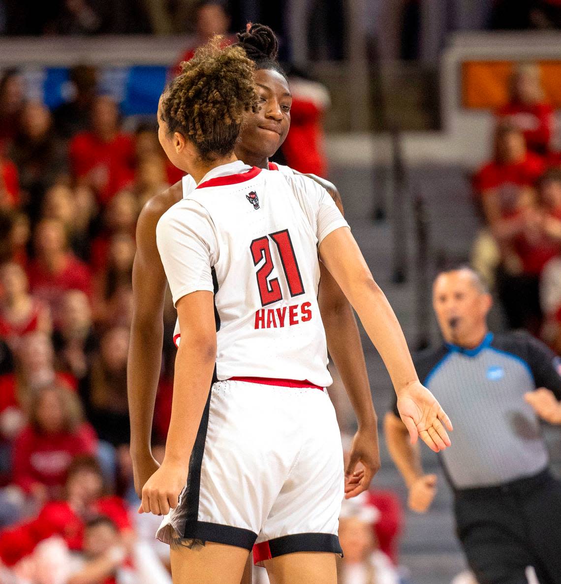 NC State’s Madison Hayes (21) and Saniya Rivers (22) shoulder bump near the end of the first half of their game against Chattanooga in the first round of the NCAA Division I Women’s Basketball Championship at Reynolds Coliseum in Raleigh, NC on Saturday, March 23, 2024.