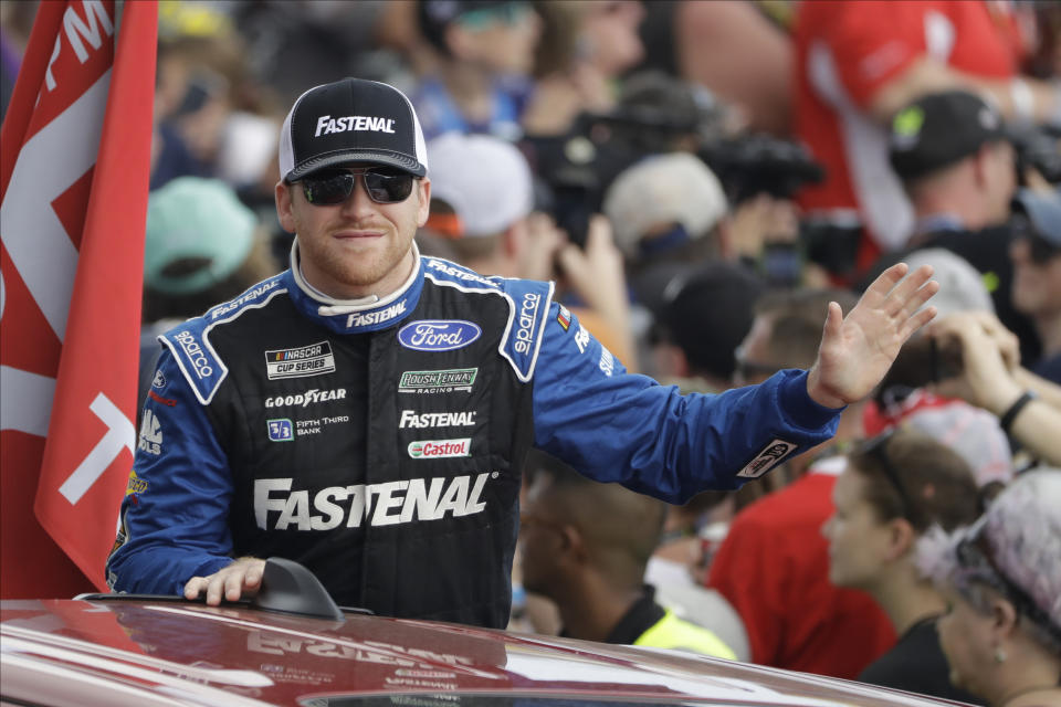 FILE - Chris Buescher gestures during a parade lap before the NASCAR Daytona 500 auto race at Daytona International Speedway in Daytona Beach, Fla., in this Sunday, Feb. 16, 2020, file photo. Roush Fenway Racing on Wednesday, May 19, 2021, announced a contract extension with both driver Chris Buescher and longtime sponsor Fastenal. The deal with Fastenal was extended through the 2024 season. (AP Photo/Chris O'Meara, File)