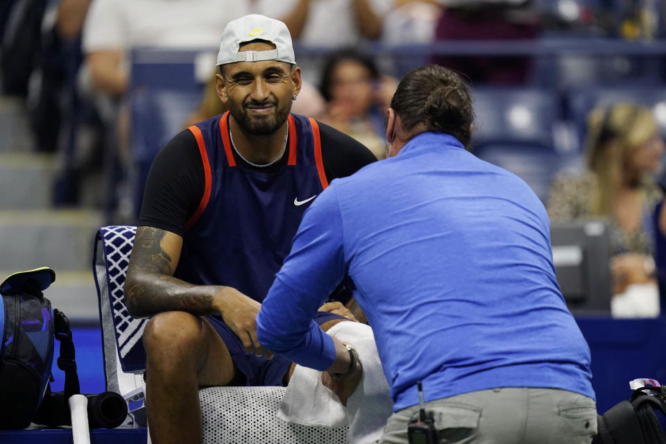 Nick Kyrgios, of Australia, is attended by a trainer as he plays Karen Khachanov, of Russia, during the quarterfinals of the U.S. Open tennis championships, Tuesday, Sept. 6, 2022, in New York. (AP Photo/Charles Krupa)