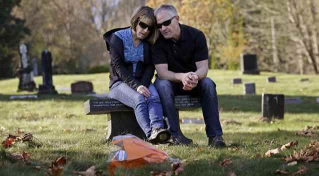 Linda and Rob Robertson visit the grave of their son Ryan. Photo: AP