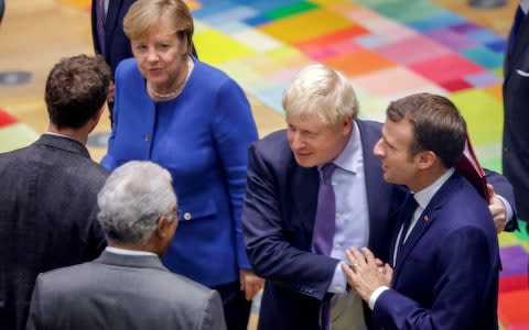 Boris Johnson, German Chancellor Angela Merkel and French President Emmanuel Macron at the EU Summit - Credit: Reuters&nbsp;