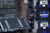 A limited number of fans gather before Game 7 of a baseball National League Championship Series Sunday, Oct. 18, 2020, in Arlington, Texas. Most of the seats of a new $1.2 billion, 40,518-capacity will be empty among the smallest crowd to view a World Series game in more than a century. (AP Photo/David J. Phillip)