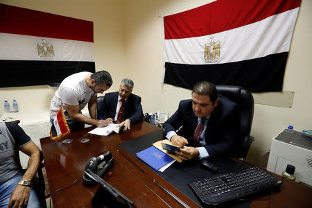 An Egyptian man living in Sudan signs up after casting his vote at the Egypt Embassy in Khartoum, Sudan March 16, 2018. REUTERS/Mohamed Nureldin Abdallah