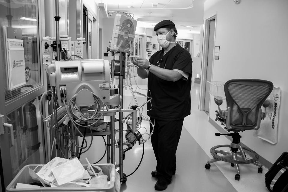 Veteran nurse Mike MacCormick builds an ECMO pump for 6-month-old Evrett Sheffield. MacCormick lost his daughter, Gabriella, to COVID-19.