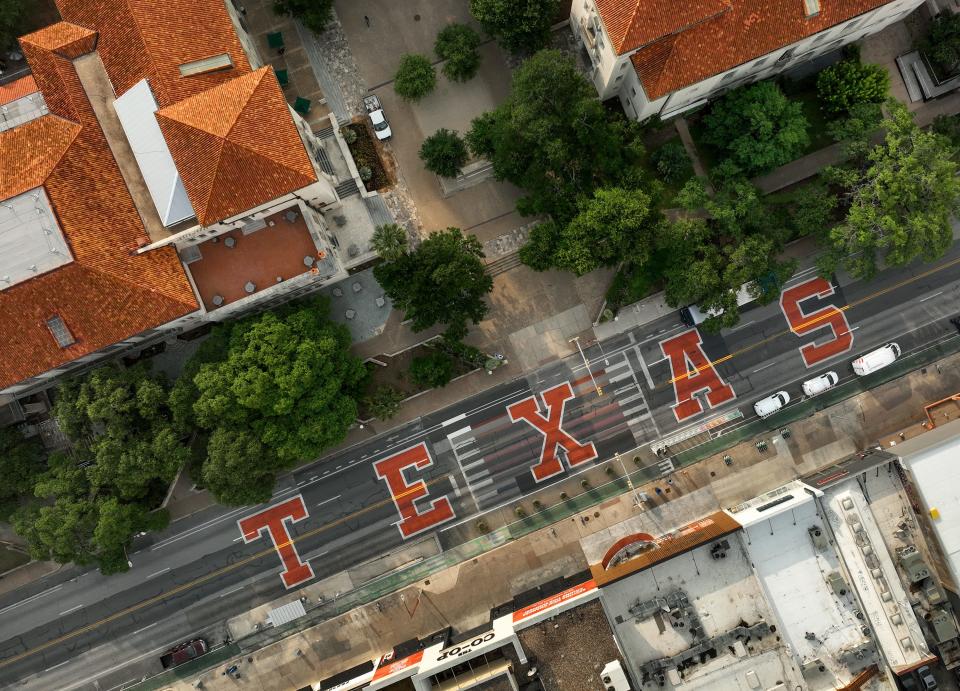 Forty-foot-tall burnt orange letters spelling "Texas" have been painted on the Drag, the stretch of Guadalupe Street along the western edge of the University of Texas. The design is part of the lead-up to a daylong event June 30 to celebrate the Longhorns' arrival in the Southeastern Conference on July 1.