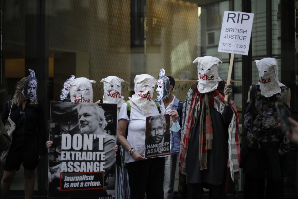 Supporters of WikiLeaks founder Julian Assange take part in a protest outside the Central Criminal Court, the Old Bailey, in London, Monday, Sept. 14, 2020. The London court hearing on Assange's extradition from Britain to the United States resumed Monday after a COVID-19 test on one of the participating lawyers came back negative, WikiLeaks said Friday. (AP Photo/Matt Dunham)