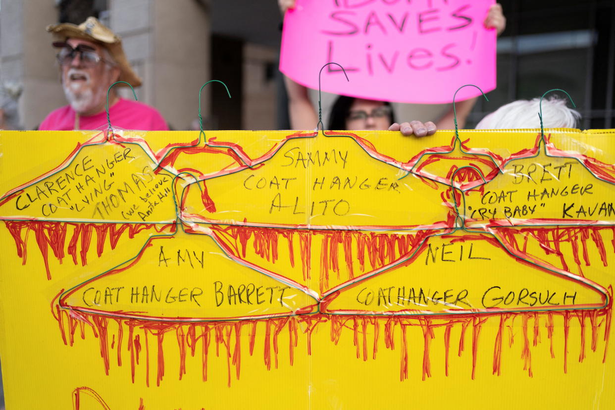 A sign decorated with bloody coat hangers and names of Supreme Court justices is seen during a demonstration outside of the federal courthouse in Tucson, Ariz., on Tuesday. (Rebecca Noble/Reuters)