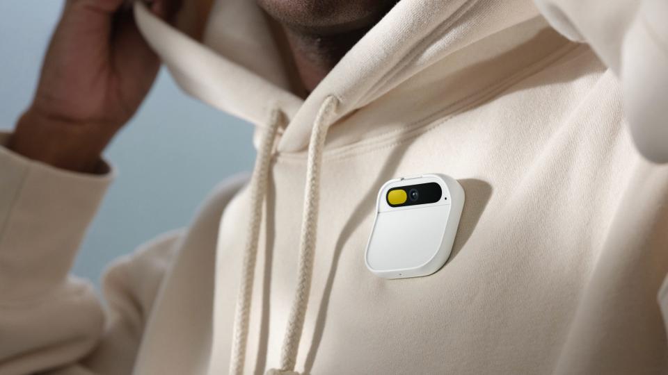 Humanitarian's Ai badge pinned to a white sweatshirt