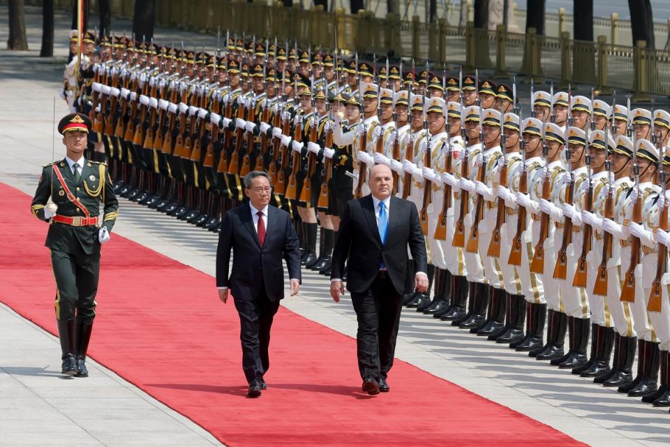 Russian prime minister Mikhail Mishustin (right) and Chinese premier Li Qiang attend a welcoming ceremony in Beijing, China (Getty Images)