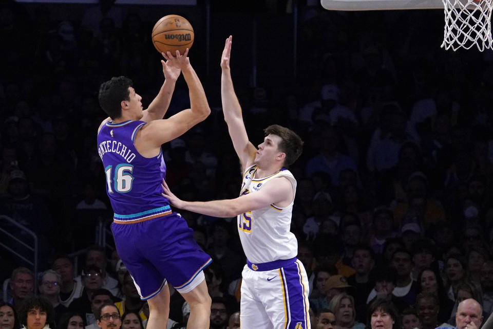 Utah Jazz forward Simone Fontecchio, left, shoots as Los Angeles Lakers guard Austin Reaves defends during the first half of an NBA basketball game Sunday, April 9, 2023, in Los Angeles. (AP Photo/Mark J. Terrill)