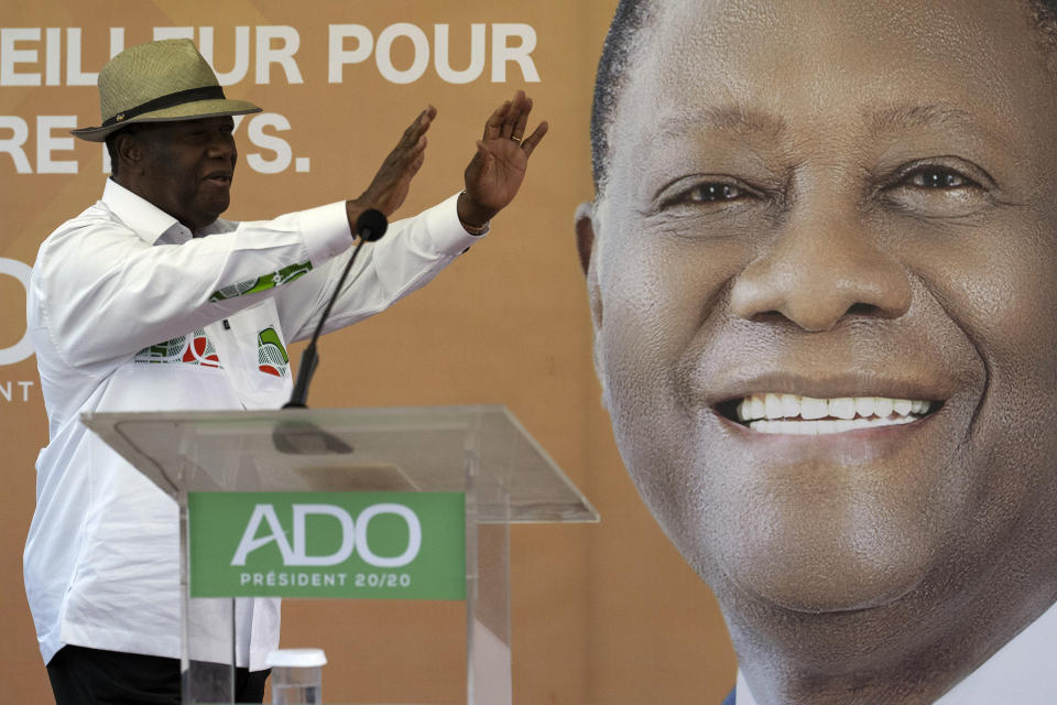 Ivory Coast President Alassane Ouattara waves to supporters before speaking at a rally in Anyama, outskirts of Abidjan, Ivory Coast, Wednesday, Oct. 28, 2020. Ouattara, who first came to power after the 2010 disputed election whose aftermath left more than 3,000 people dead, is now seeking a third term in office. The candidate maintains that he can serve a third term because of changes to the country's constitution, though his opponents consider his candidacy illegal. (AP Photo/Leo Correa)