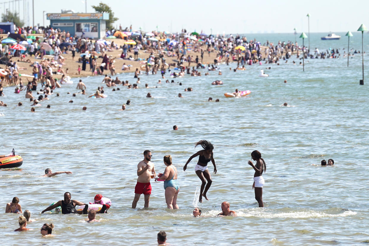 People gather in the hot weather at Southend-on-Sea beach. A drought has been declared for parts of England following the driest summer for 50 years. Picture date: Sunday August 14, 2022.