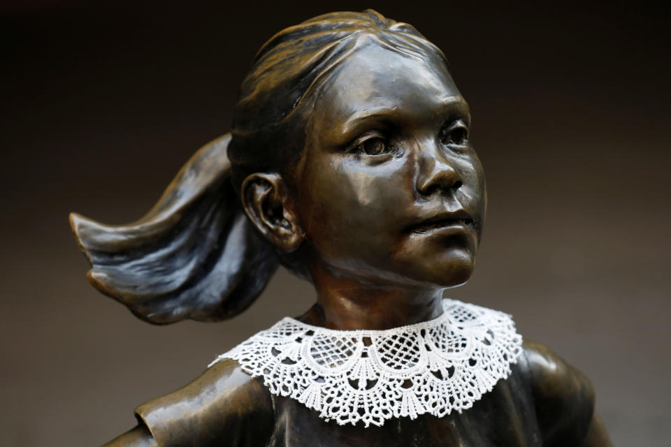 A jabot collar is seen placed on the Fearless Girl statue in honor of recently passed Associate Justice of the Supreme Court of the United States Ruth Bader Ginsburg in Manhattan, New York City, U.S., September 21, 2020. REUTERS/Andrew Kelly