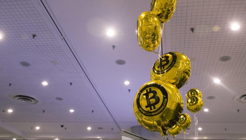 Bitcoin themed balloons float in the air during the "Inside Bitcoins: The Future of Virtual Currency Conference" in New York