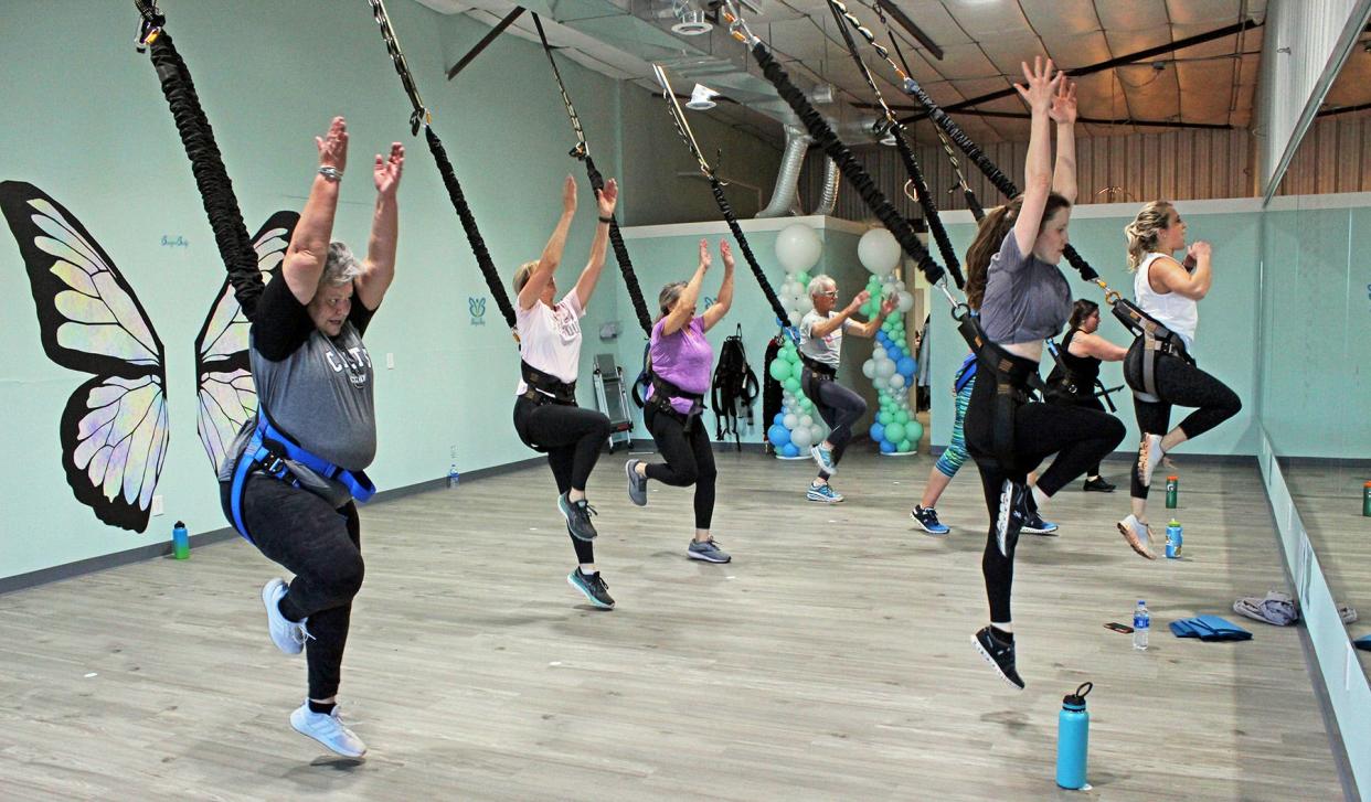 Nicole Clementi (far right) teaches a fitness class at the new Bungee Body business in Pueblo. Bungee cords attached to the ceiling help relieve up to 70% of the impact on the exercisers' joints.