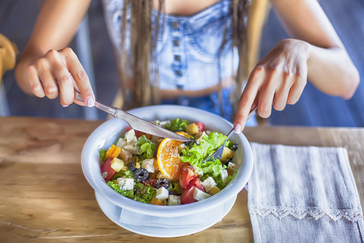 A teen digs in to a healthy salad. Why pediatricians and experts say it's a bad idea to encourage your child to diet. 
