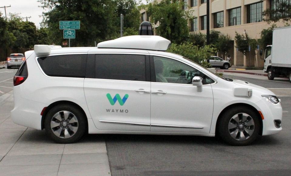 In this file photo taken on May 08, 2019, Waymo self-driving car pulls into a parking lot at the Google-owned company's headquarters in Mountain View, California.