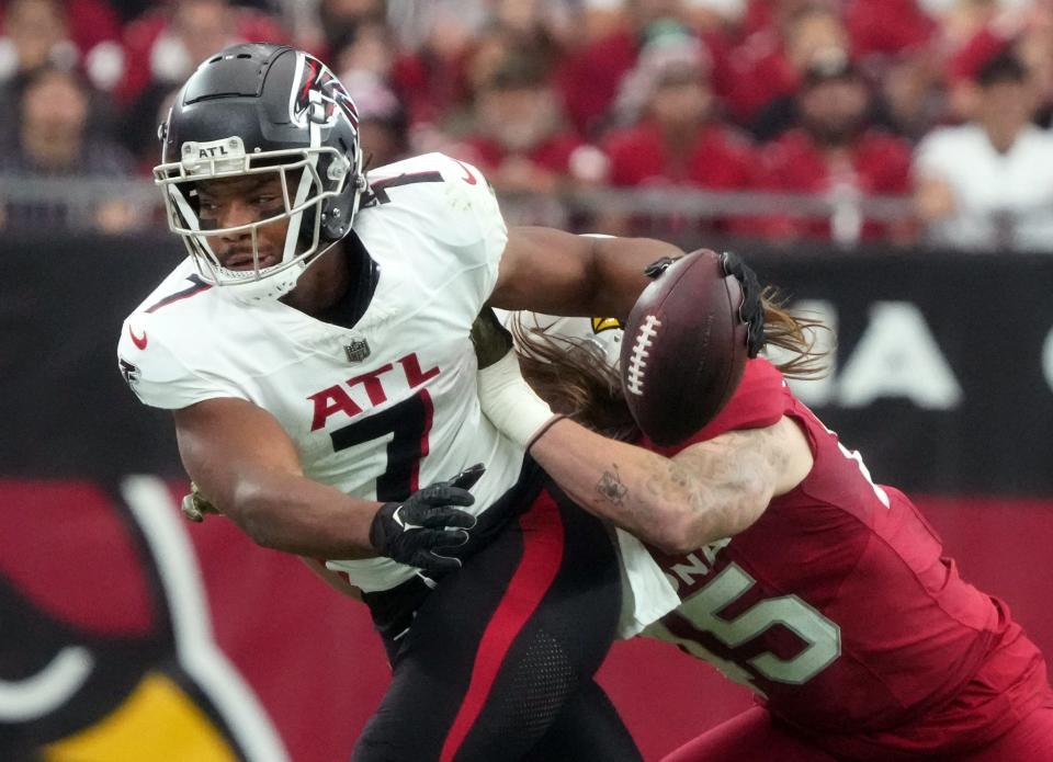 Arizona Cardinals linebacker Dennis Gardeck (45) pushes Atlanta Falcons running back Bijan Robinson (7) out of bounds at State Farm Stadium on Nov. 12, 2023, in Glendale.