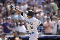 Colorado Rockies' Joshua Fuentes gestures as he crosses home plate after hitting a solo home run off Milwaukee Brewers relief pitcher Zack Godley in the sixth inning of a baseball game Sunday, June 20, 2021, in Denver. (AP Photo/David Zalubowski)