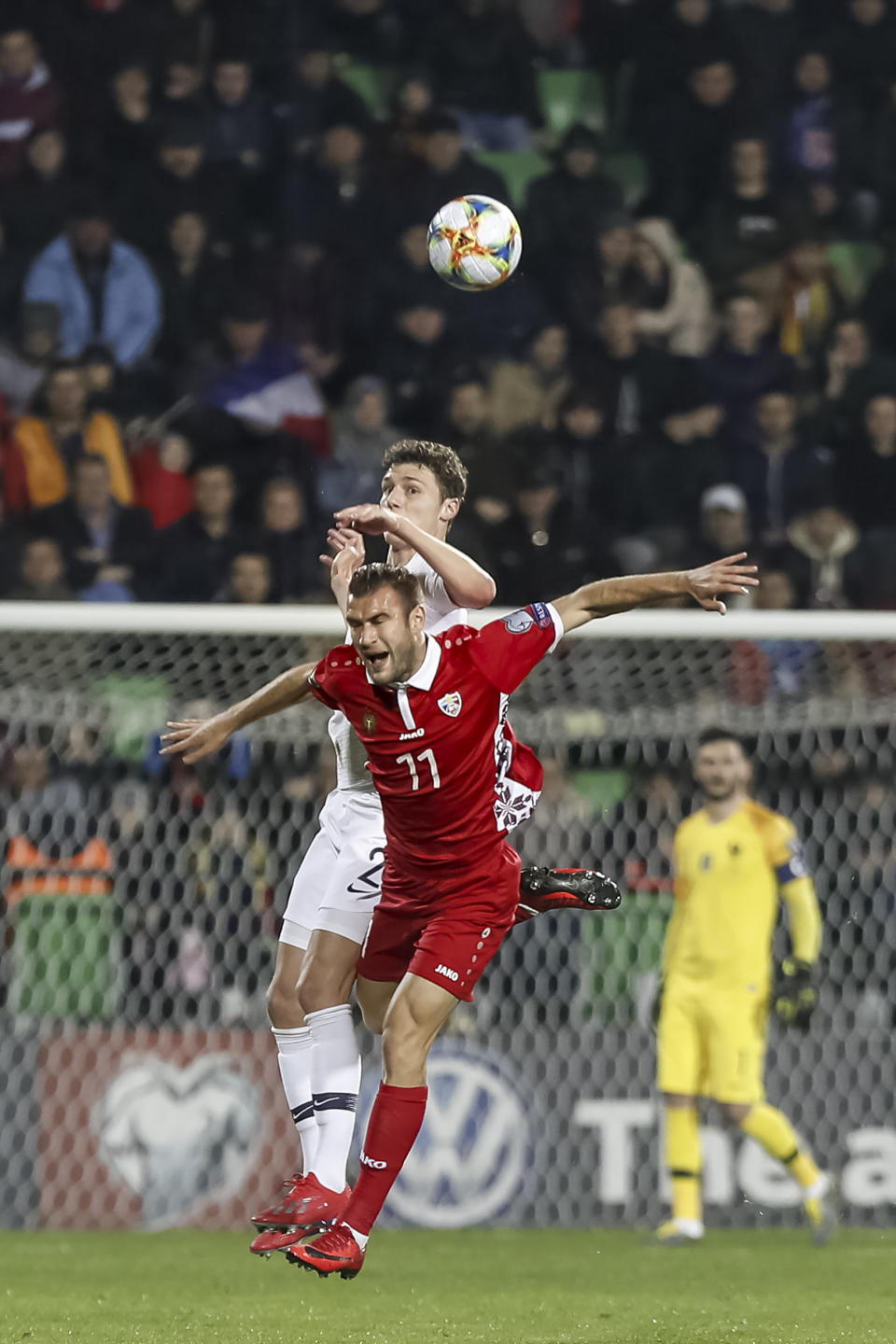 France's Benjamin Pavard left, fights for the ball with Moldova's Radu Ginsari right, during the Euro 2020 group H qualifying soccer match between Moldova and France at Zimbru stadium in Chisinau, Moldova, Friday, March 22, 2019. (AP Photo/ Roveliu Buga)