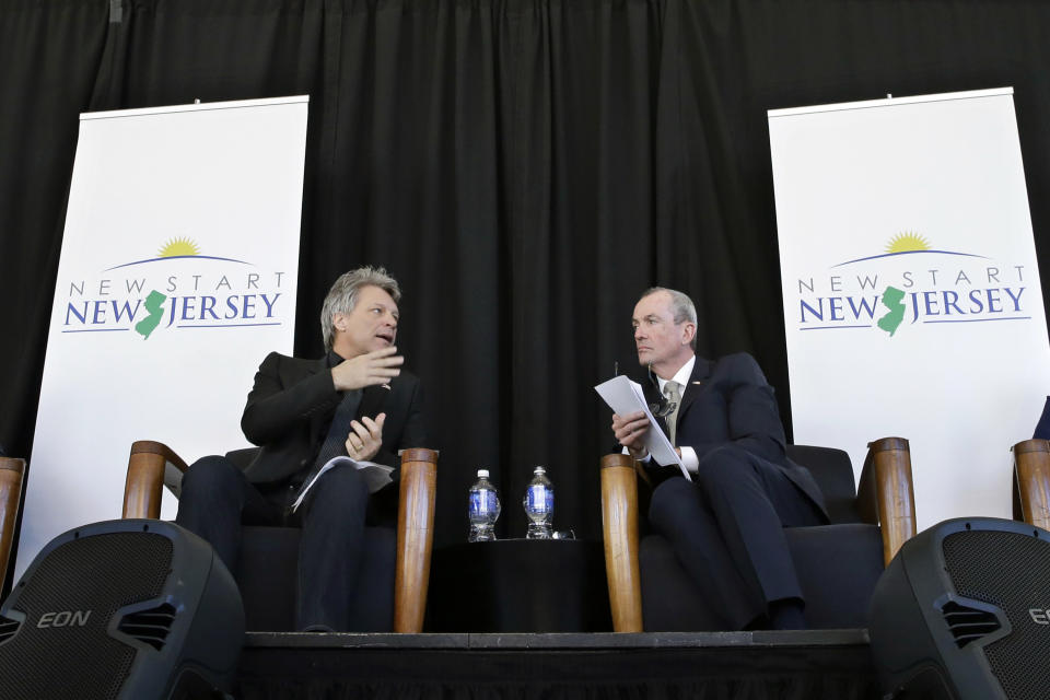 FILE – In this Nov. 10, 2014, file photo, Philip Murphy, right, former U.S. ambassador to Germany in President Barack Obama's administration, listens as rock musician Jon Bon Jovi, left, speaks during an event to launch New Start New Jersey, a group seeking to influence policy in support of New Jersey's middle class, in Newark, N.J. Jim Johnson, a former treasury official in President Bill Clinton's administration, requested Thursday, March 30, 2017, that the Election Law Enforcement Commission investigate Murphy, a Democratic candidate for New Jersey governor and former Goldman Sachs executive. Johnson's campaign alleges two groups Murphy set up before officially entering the governor's race, New Start New Jersey and New Way for New Jersey, constituted exploratory committees. (AP Photo/Mel Evans, File)