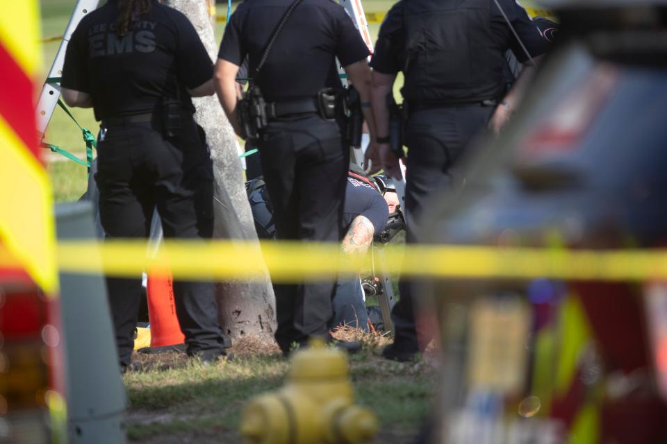 Emergency officials work a scene on Hill Avenue next to the Fort Myers Country Club on on Wednesday, May 22, 2024. A woman is dead after intentionally entering a storm drain system. Emergency and public works officials worked for hours to try to rescue her but she died.