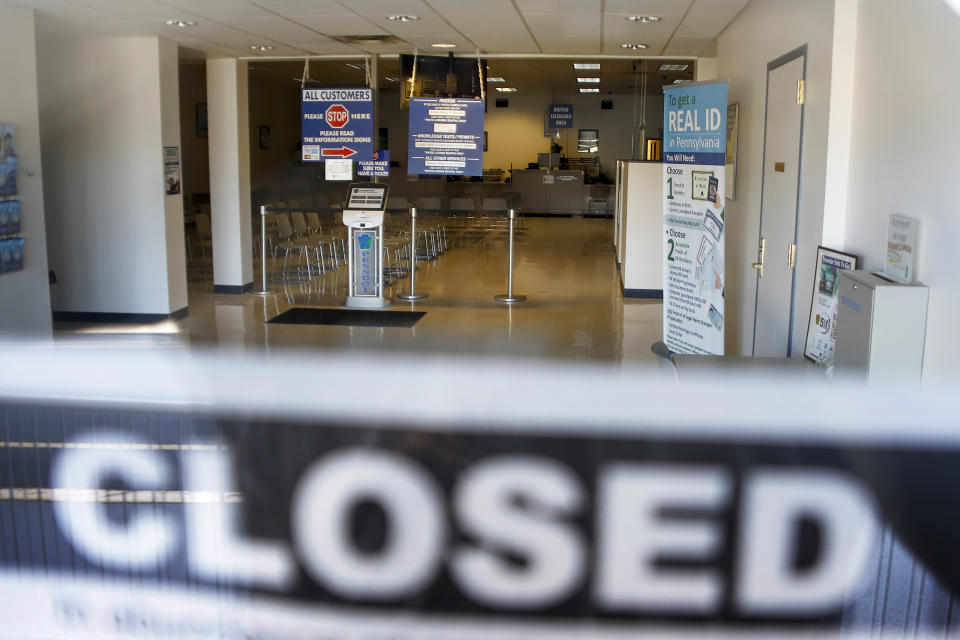 FILE - In this April 3, 2020, file photo, the seats and aisles are empty as seen through the window of the closed Penndot Drivers License Center in Butler, Pa. Small business owners hoping for quick loans from the government were in a holding pattern Monday, April 6, 2020, waiting on their bank to either take their application or, if it did, send them the money. (AP Photo/Keith Srakocic, File)