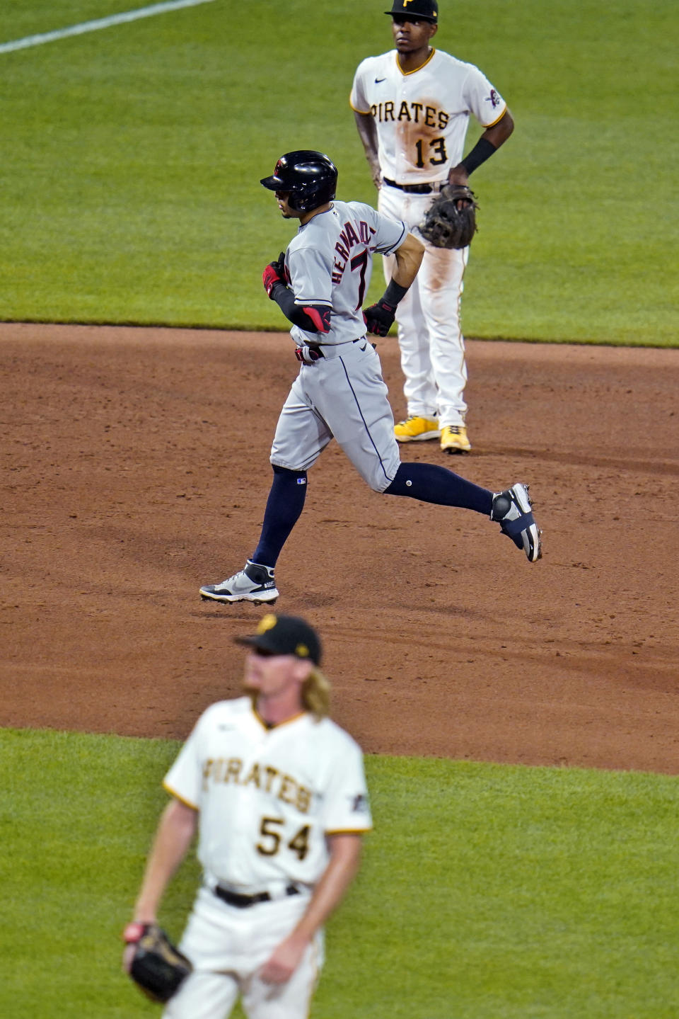 Cleveland Indians' Cesar Hernandez (7) runs the bases after hitting a grand slam off Pittsburgh Pirates relief pitcher Sam Howard (54) during the seventh inning of a baseball game in Pittsburgh, Friday, June 18, 2021. (AP Photo/Gene J. Puskar)