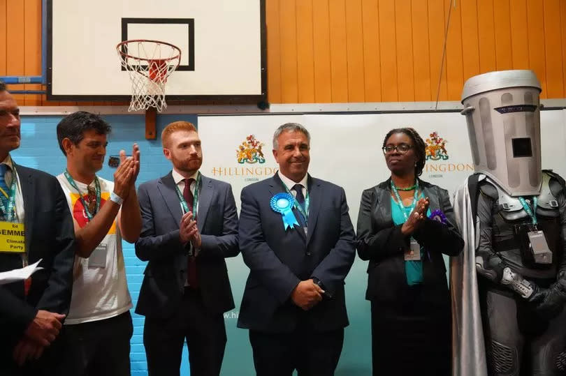 Conservative Party candidate, Steve Tuckwell (C), celebrates winning the Uxbridge and South Ruislip by-election as Labour Party candidate Danny Beales (3rd L)