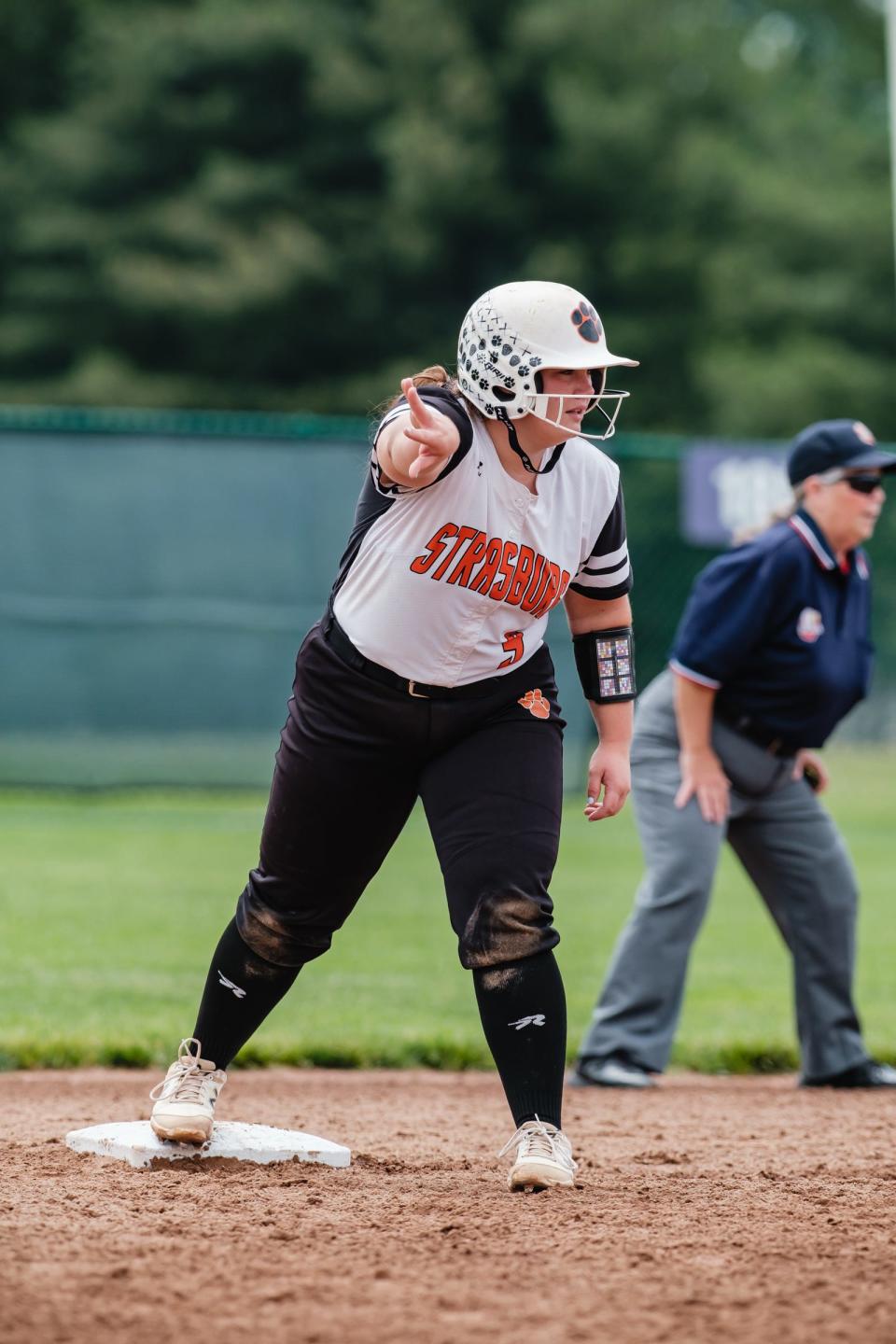 Strasburg's Emma Gilkerson signals to teammates after hitting a double to left field during their Division IV regional championship game.