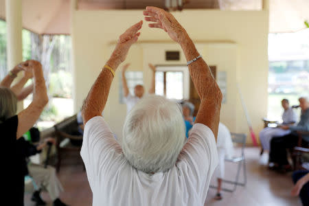 A group of retired foreigners attend a Tai Chi class, while staying at the Care Resort in Chiang Mai, Thailand April 6, 2018. Picture taken April 6, 2018. REUTERS/Jorge Silva