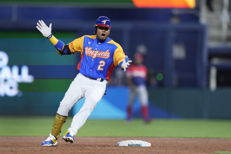 Venezuela's Luis Arraez celebrates after hitting a double during the first inning of a World Baseball Classic game against the Dominican Republic, Saturday, March 11, 2023, in Miami. (AP Photo/Wilfredo Lee)