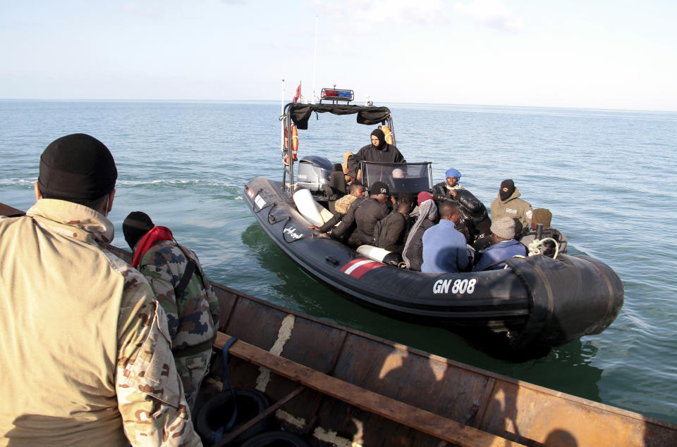 Migrants board a boat after getting stopped by Tunisian Maritime National Guard at sea during an attempt to get to Italy, near the coast of Sfax, Tunisia, Tuesday, April 18, 2023. The Associated Press, on a recent overnight expedition with the National Guard, witnessed migrants pleading to continue their journeys to Italy in unseaworthy vessels, some taking on water. Over 14 hours, 372 people were plucked from their fragile boats. (AP Photo)