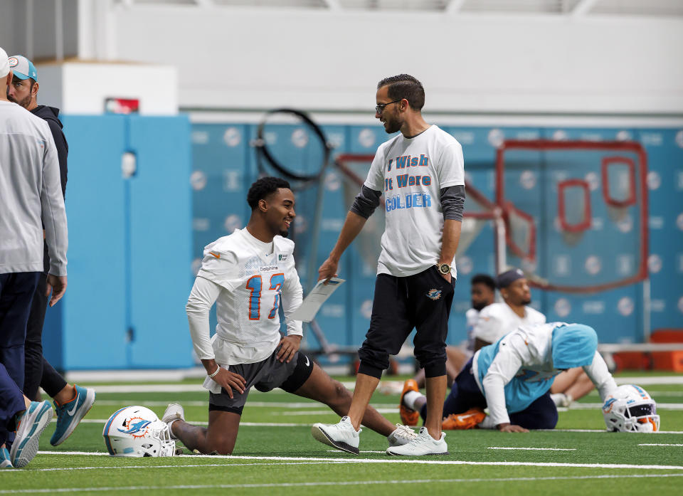 Miami Dolphins head coach Mike McDaniel talks to Dolphins wide receiver Jaylen Waddle during NFL football practice, Wednesday, Dec. 14, 2022, in Miami Gardens, Fla. (David Santiago/Miami Herald via AP)