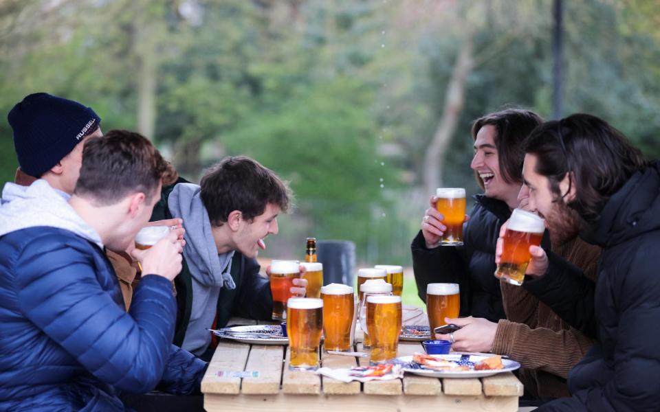 people drinking beer - HANNAH MCKAY/REUTERS