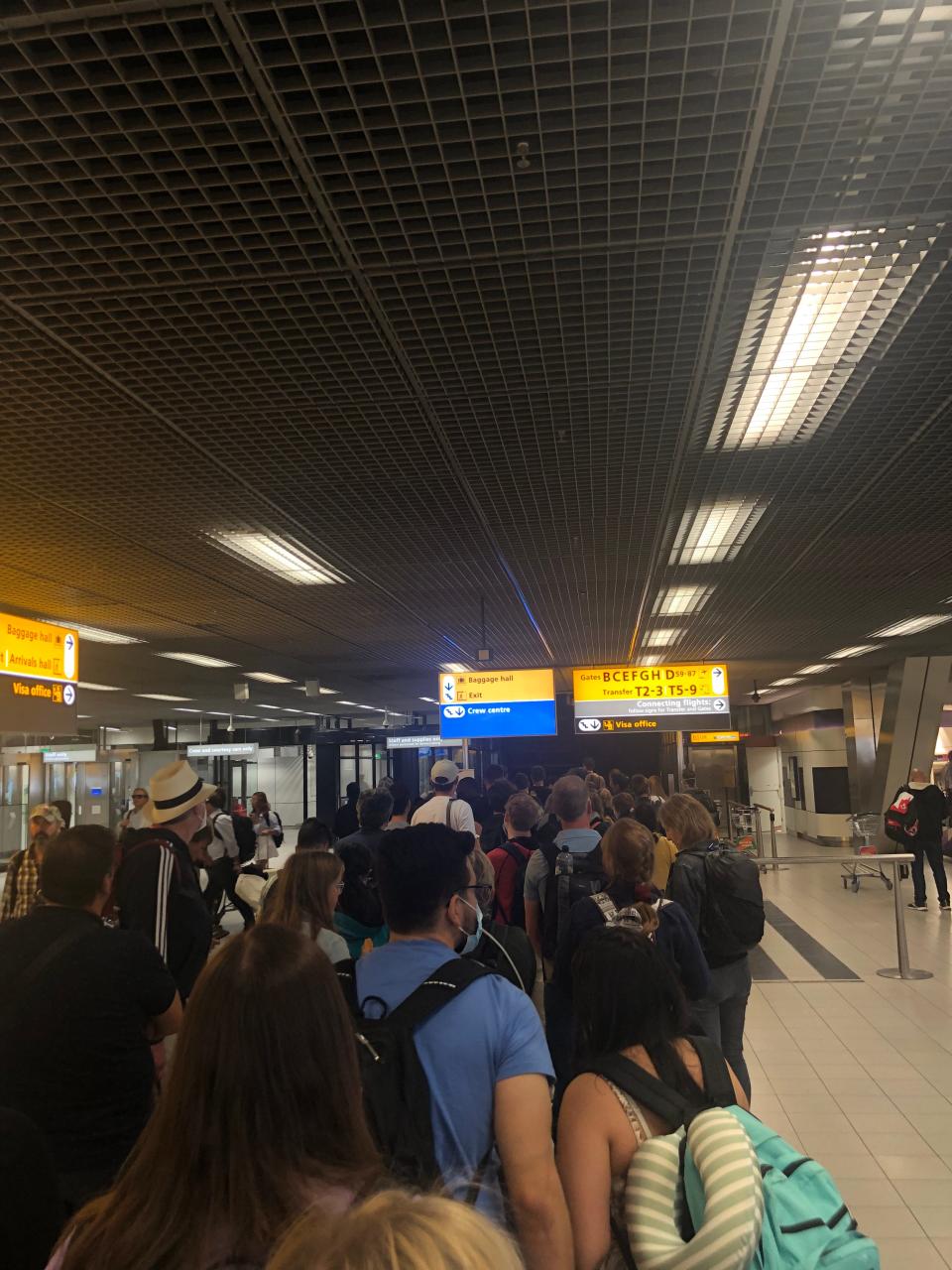 A line to get on the customs line at Amsterdam Schiphol Airport.